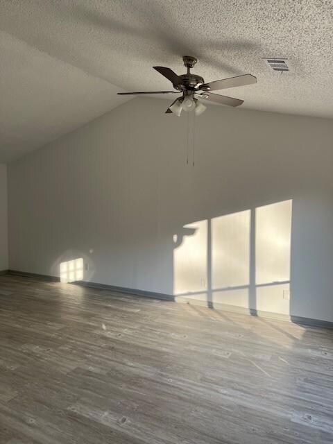 Additional living space featuring ceiling fan, woo