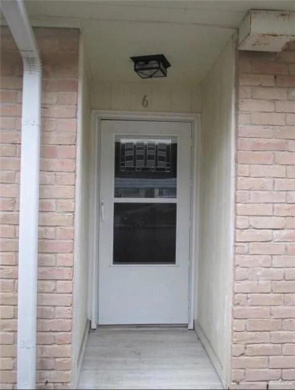 View of exterior entry with brick siding