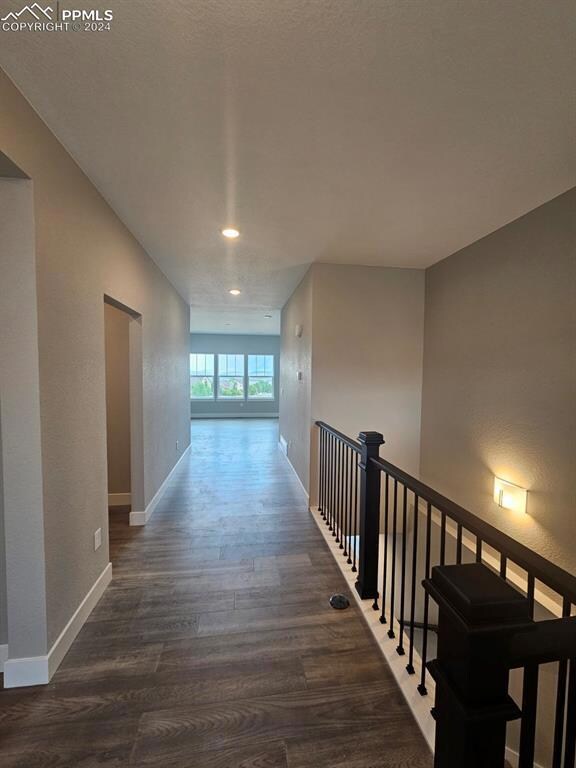 Hall with hardwood / wood-style floors