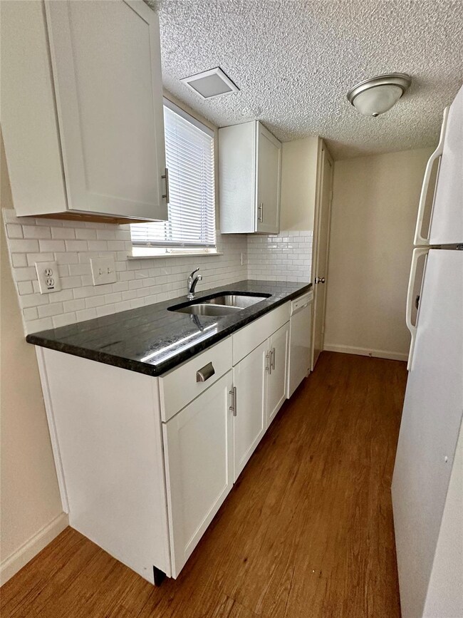 Kitchen featuring white appliances, wood finished
