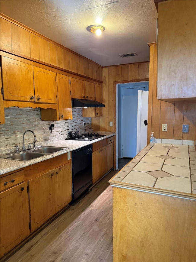 Kitchen featuring cooktop, light wood-type floorin