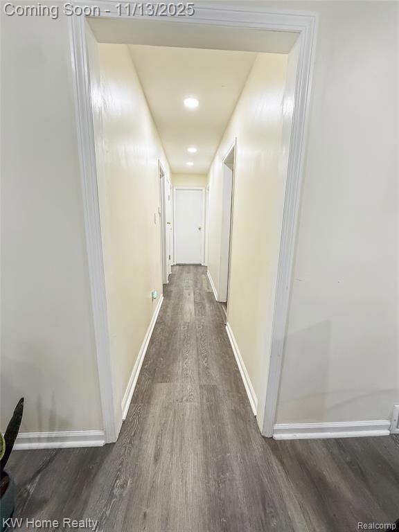 Hall featuring dark wood-style flooring and recessed lighting