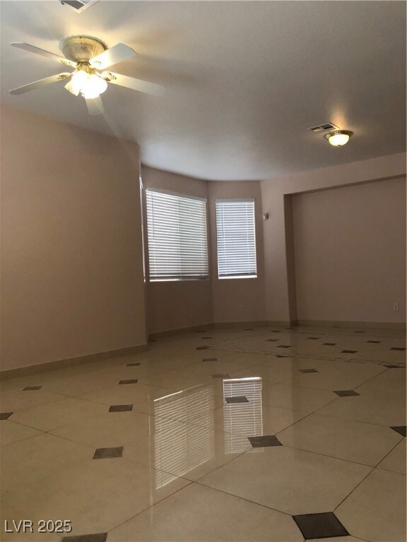 Empty room with tile patterned flooring, visible v