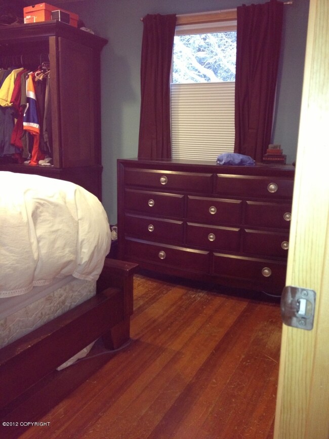 master bedroom w/ hardwood floors