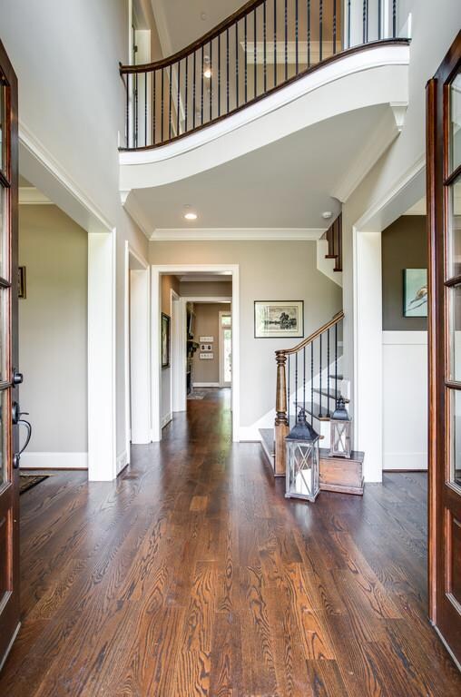 From rich hardwood floors to the dramatic upstairs walkway above, everything about this entry reflects impeccable choices, quality craftsmanship and a faultless aesthetic that is found throughout the rest of the home and property.