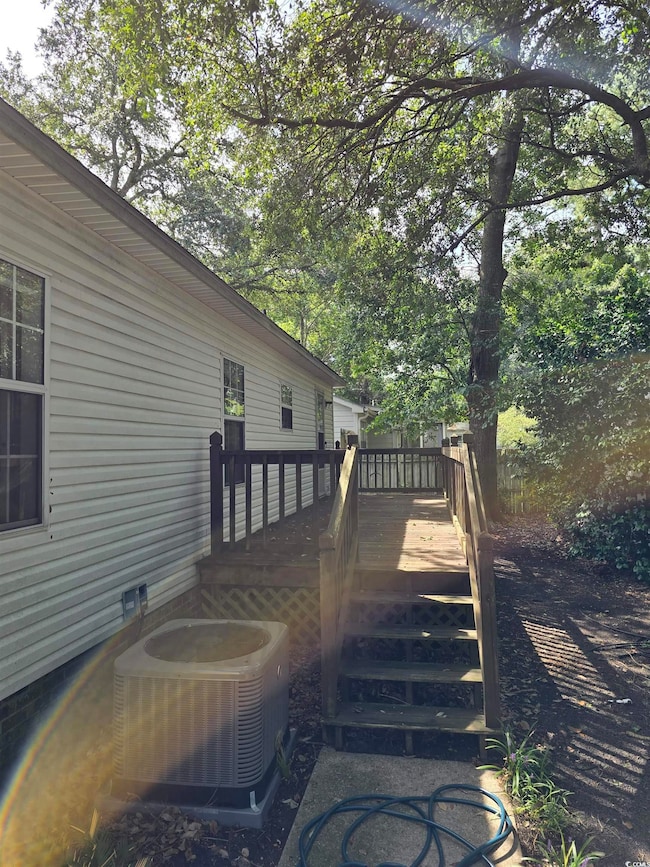 Exterior space with central AC unit and a deck