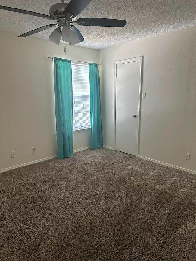 Empty room featuring baseboards, carpet flooring, 