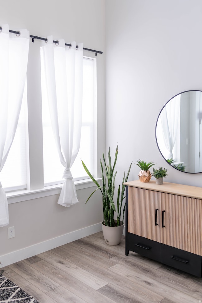 Living area featuring light wood-style flooring and baseboards