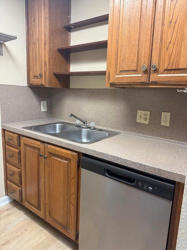 Kitchen featuring stainless steel dishwasher, a s