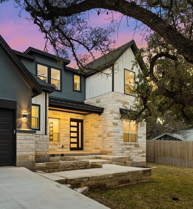 View of front facade with stone siding and stucco