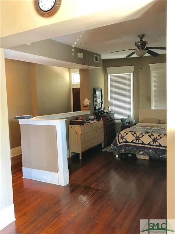 Front room which is being used as a bedroom area b
