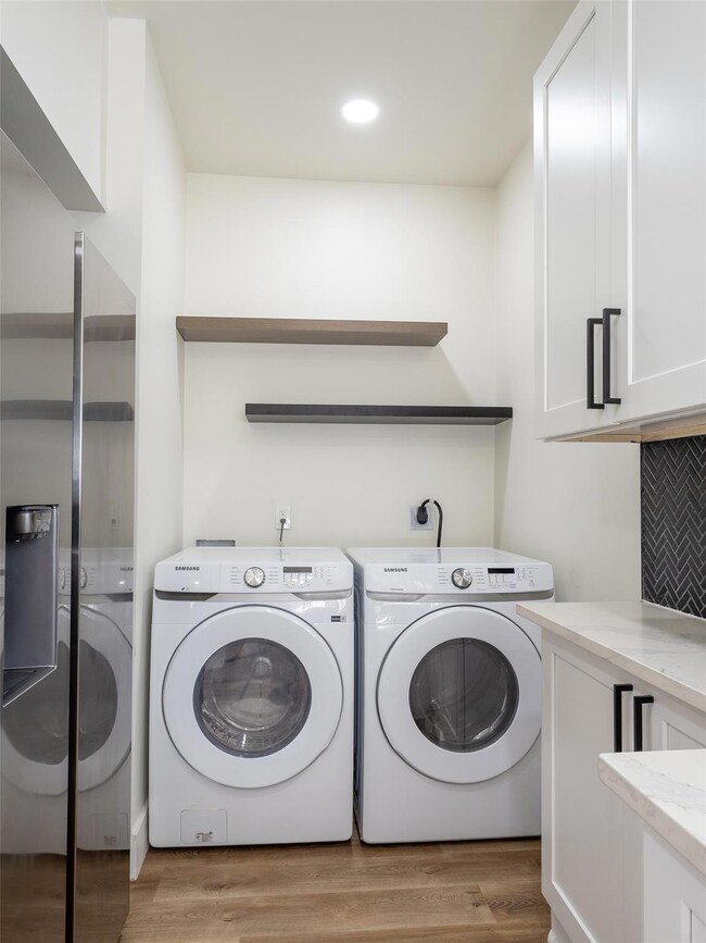 Laundry room with washing machine and dryer, cabi