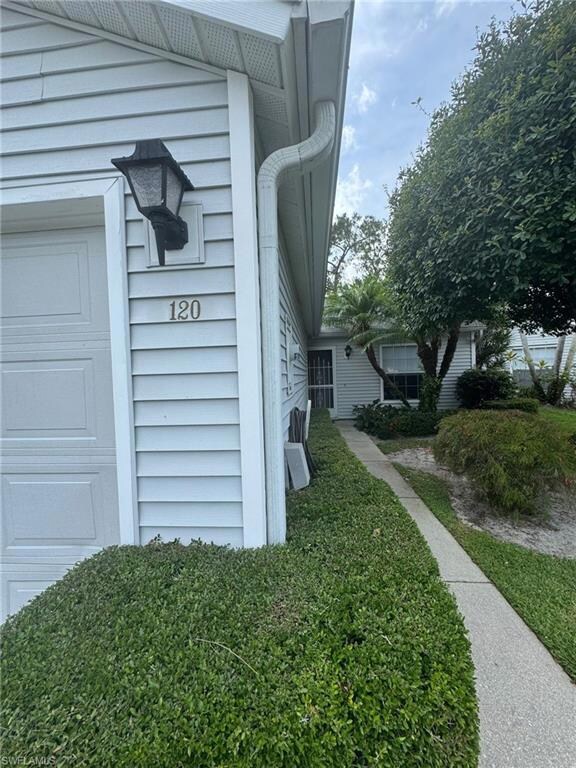 View of property exterior featuring a garage