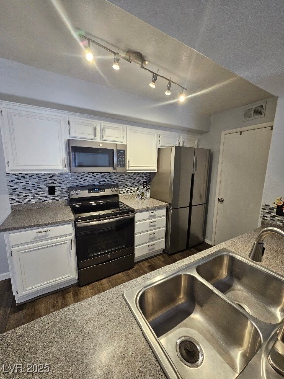 Kitchen with a sink, tasteful backsplash, applianc