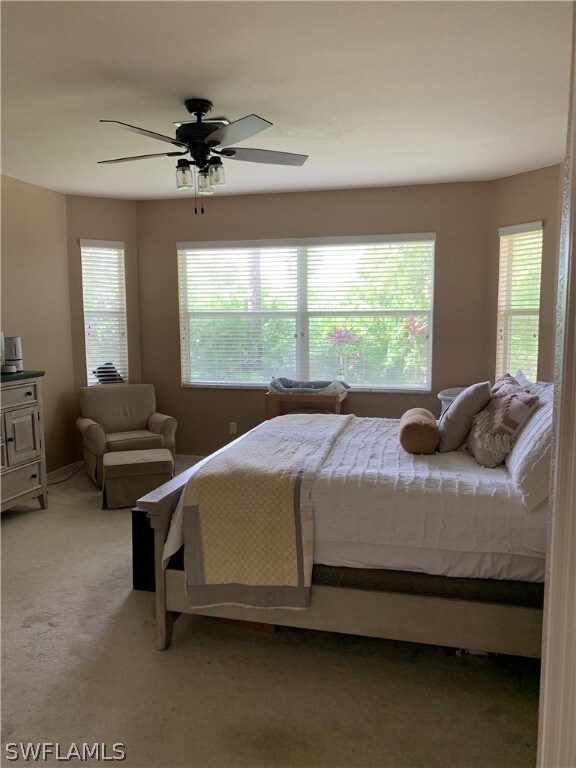 Master bedroom with view out back of landscaped ar
