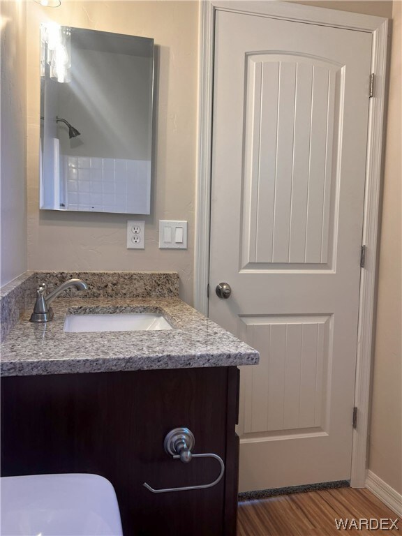 Bathroom with hardwood flooring and large vanity
