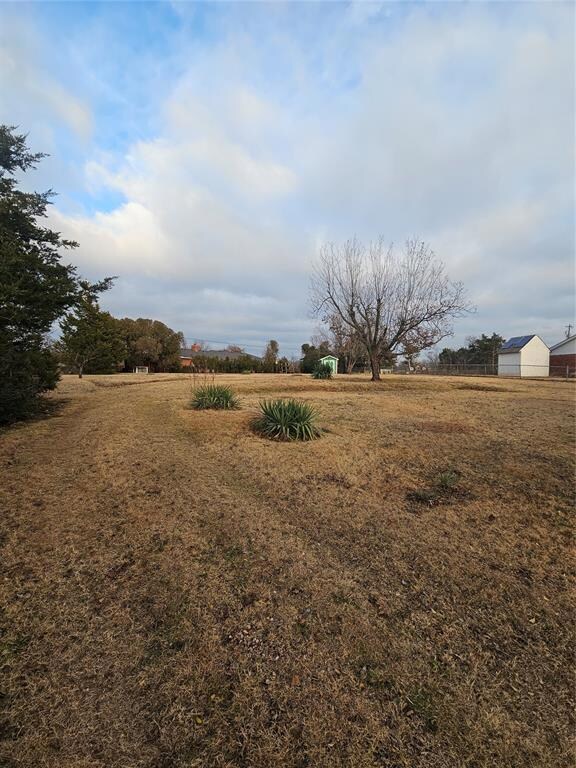 View of yard with a rural view