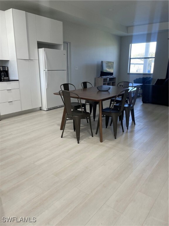 Dining space with light hardwood / wood-style floors