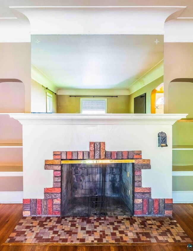 Unfurnished living room with a brick fireplace and