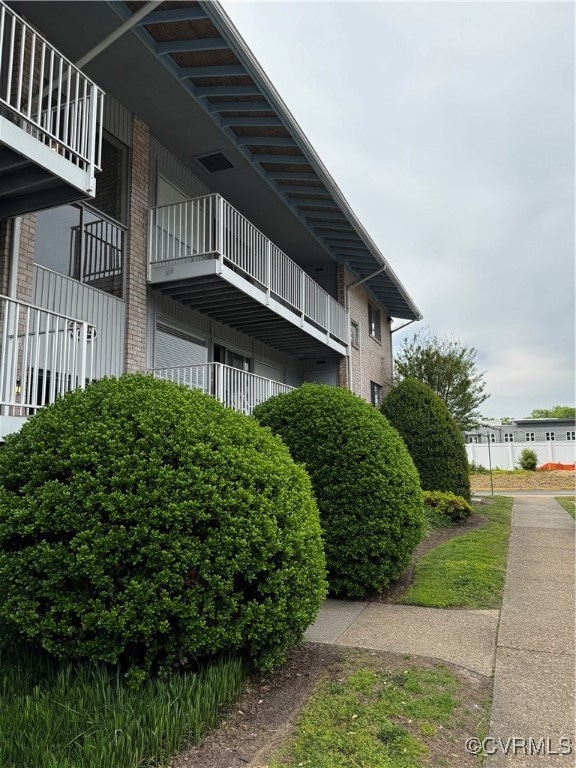 View of property exterior with brick siding