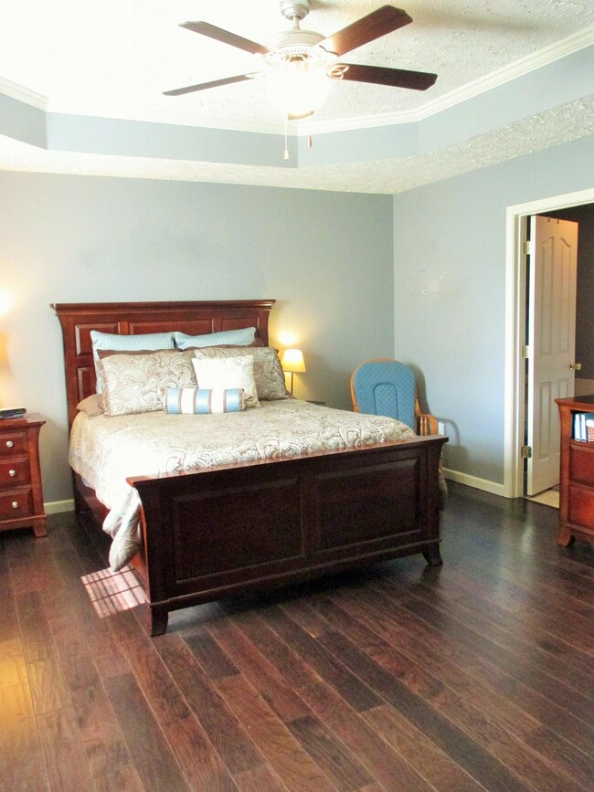 Off the living room you find the master suite. Bedroom has hardwood, trey ceiling and walk-in closet.