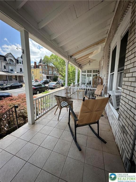Wide front porch with newer tile floor