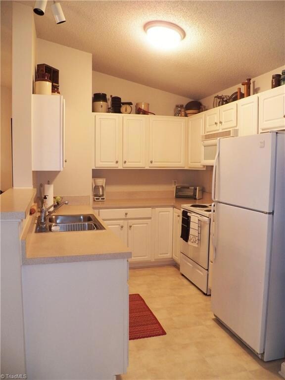 The kitchen offers cathedral ceilings, ample counter space and storage as well as a nice breakfast bar.