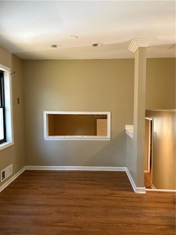 Unfurnished room with dark wood-style floors and recessed lighting
