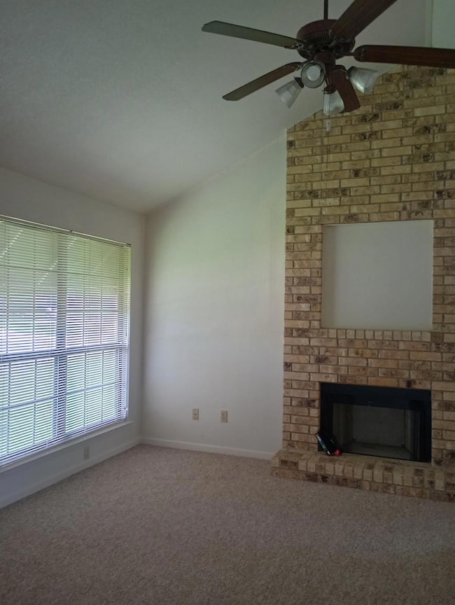 Unfurnished living room featuring a ceiling fan, 