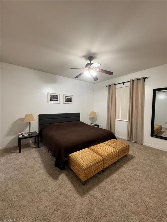 Carpeted bedroom with ceiling fan