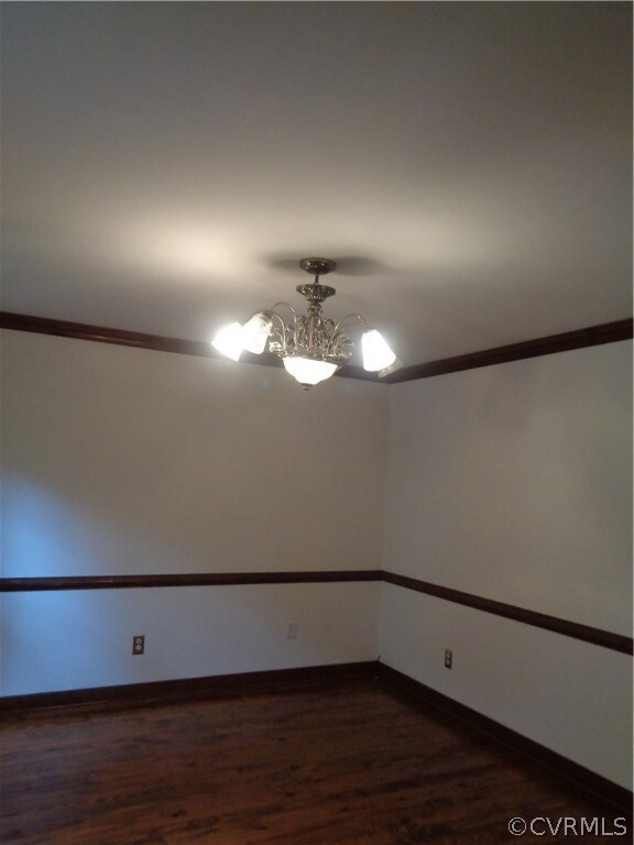 Formal Dining Room with wood flooring, crown moldi