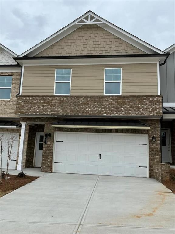Multi unit property featuring brick siding, drivew