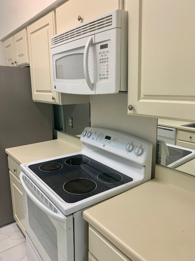Kitchen showing Cooking Range & microwave