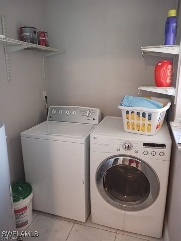 Clothes washing area featuring washer and dryer