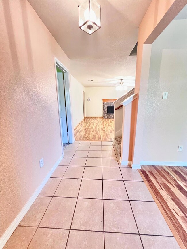 Corridor featuring tile patterned flooring