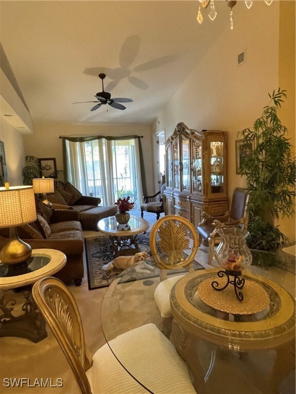 Carpeted living room featuring ceiling fan
