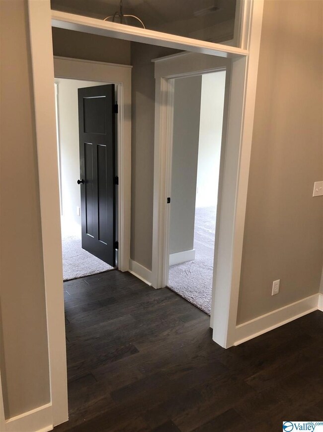 These oversized bedrooms share a bath with a door between the double sinks and the shower/commode areas.