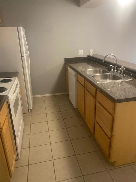 Kitchen featuring white appliances, light tile pa