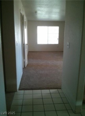Corridor with carpet floors and tile patterned flo