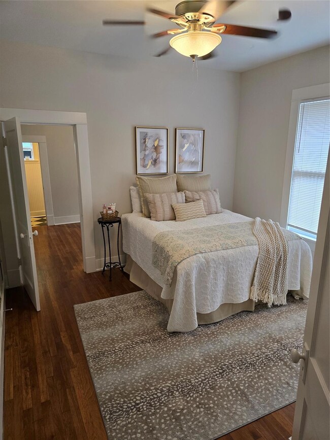Bedroom featuring ceiling fan and dark hardwood / 