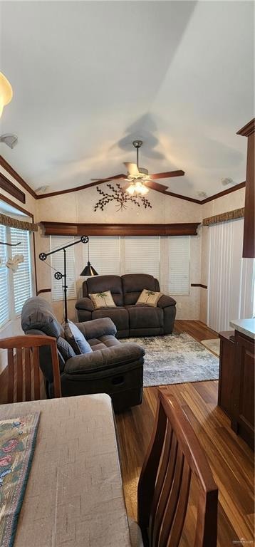 Living area with lofted ceiling, wood finished floors, ceiling fan, and crown molding