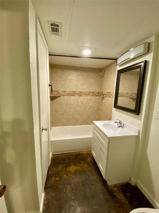This bathroom features a bathtub with tiled walls