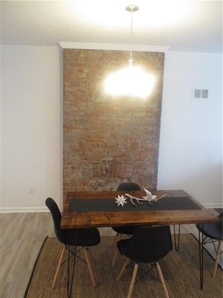Dining space and exposed brick fireplace