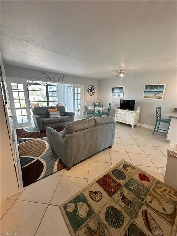 Living room featuring baseboards and light tile pa