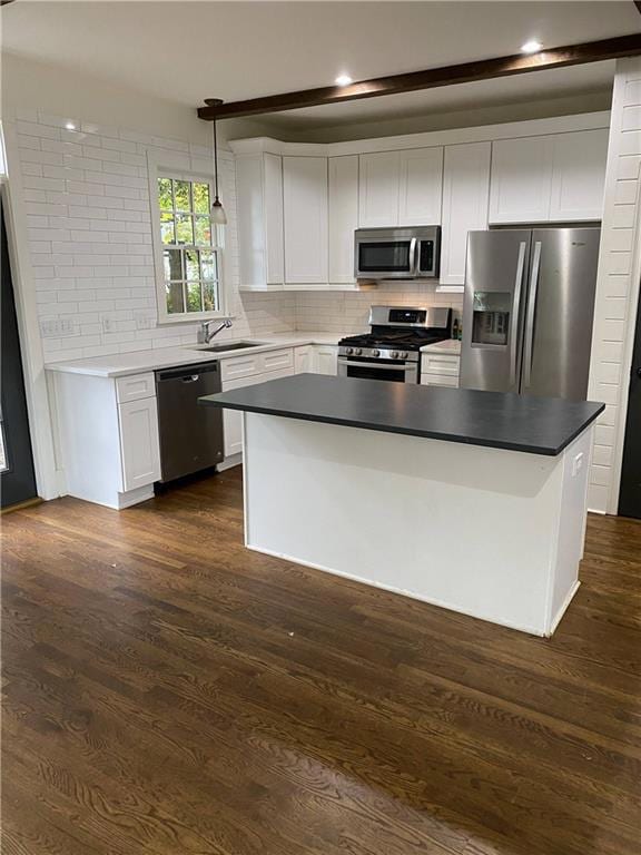 Kitchen featuring stainless steel appliances, tasteful backsplash, white cabinets, hanging light fixtures, and recessed lighting