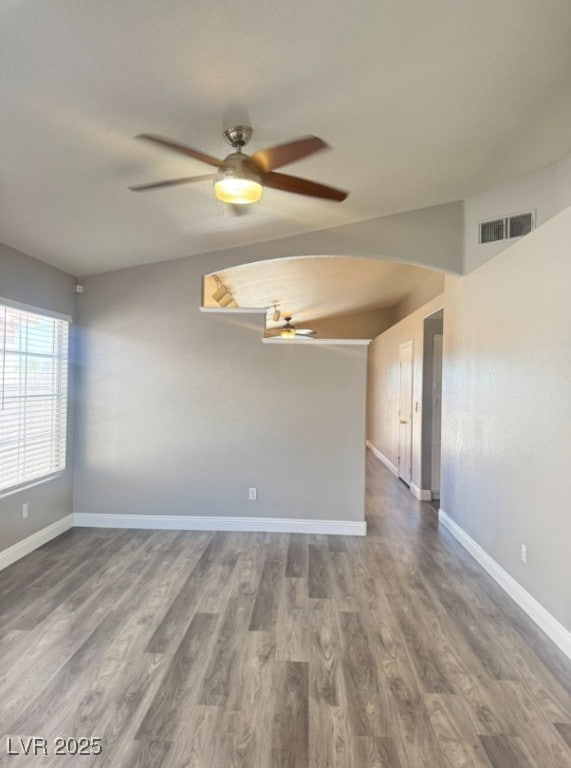Empty room with wood finished floors and ceiling fan