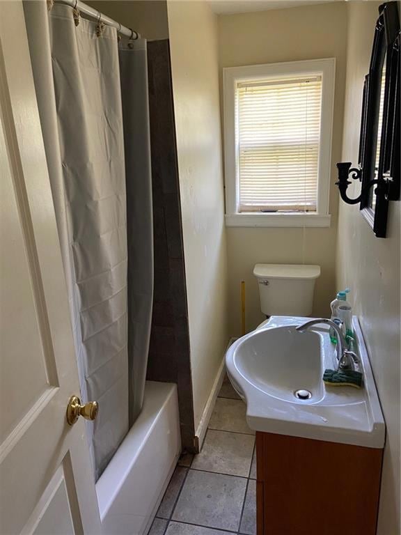 Bathroom featuring baseboards, toilet, vanity, shower / bath combo with shower curtain, and tile patterned flooring