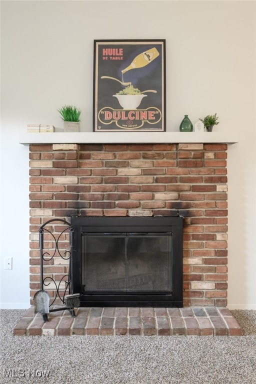 Detailed view of carpet flooring and a fireplace