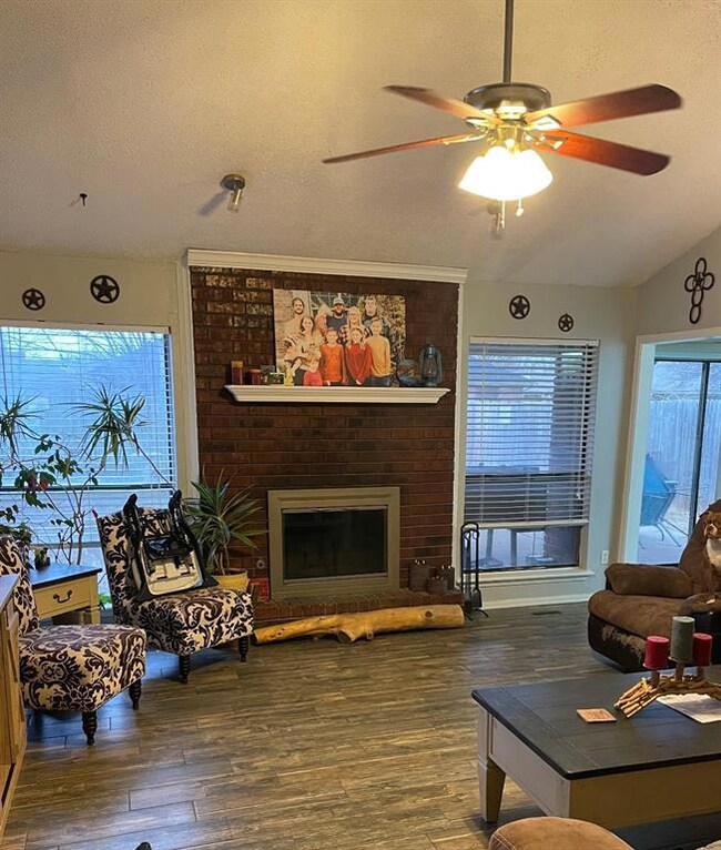 Living room featuring lofted ceiling, dark wood-ty