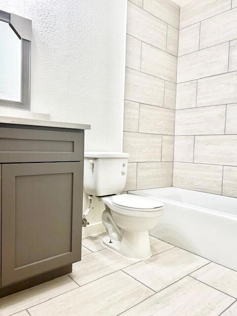 Full bath with toilet and vanity